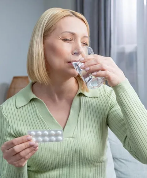 A lady taking a medicine